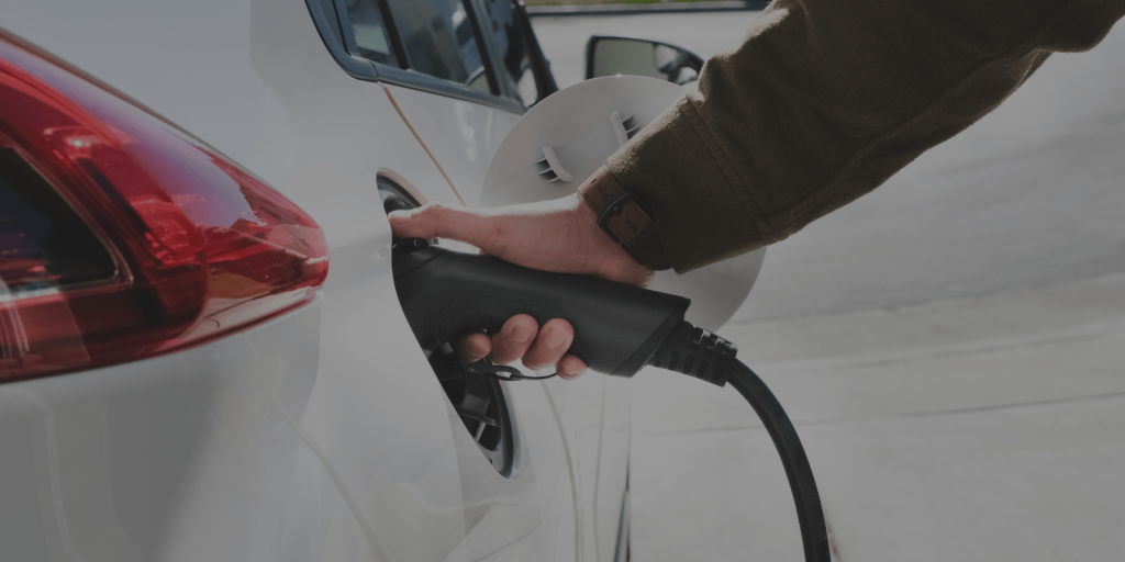 An image of an individual charging their electric vehicle