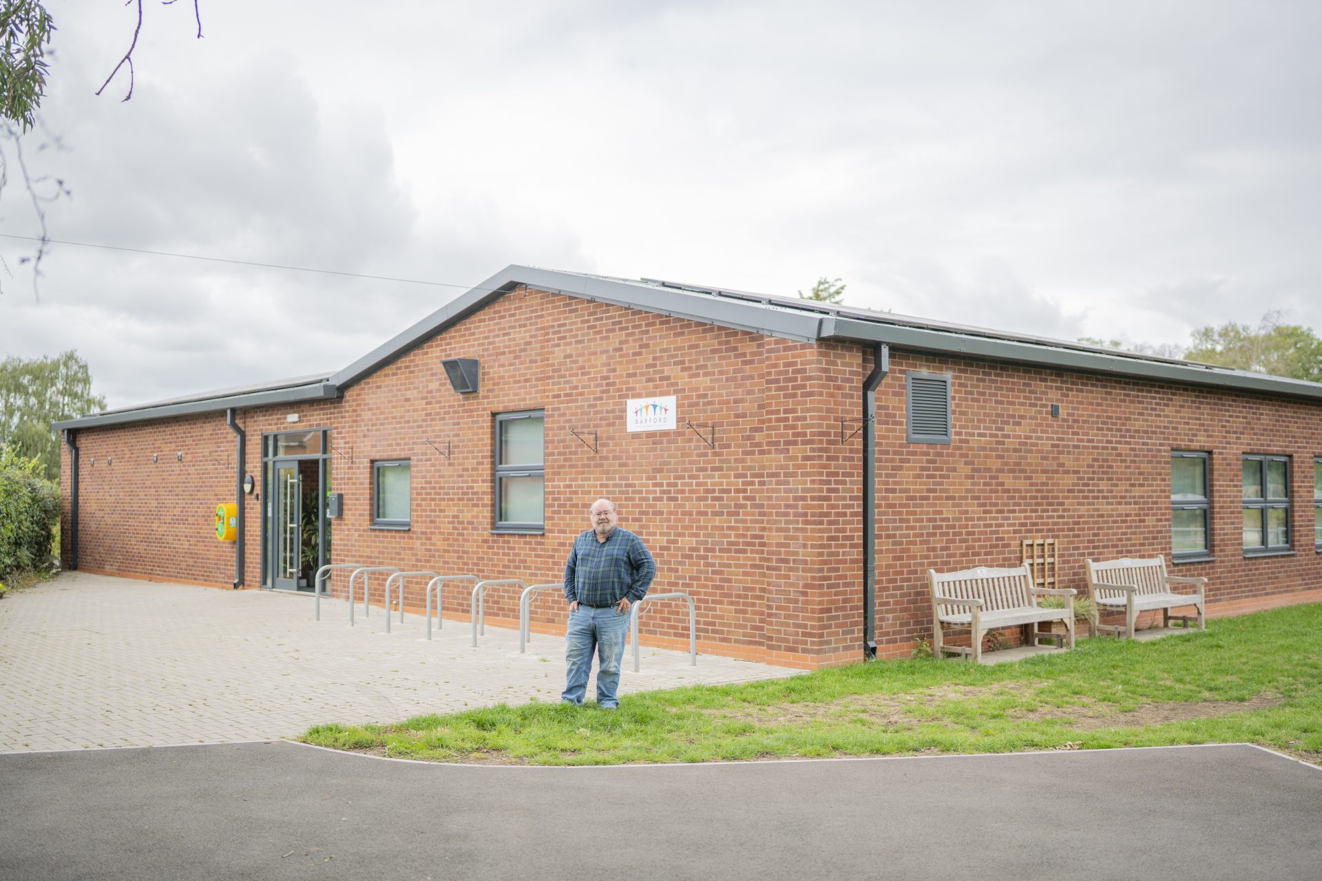 Ian Paterson, Chairman of Barford Youth & Community Centre, standing outside the front entrance of the building.