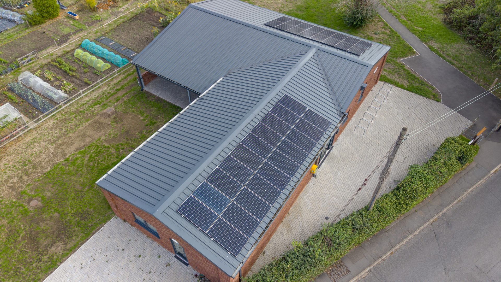 An aerial view of solar panels installed on the roof of Barford Youth & Community Centre by Stratford Energy Solutions.